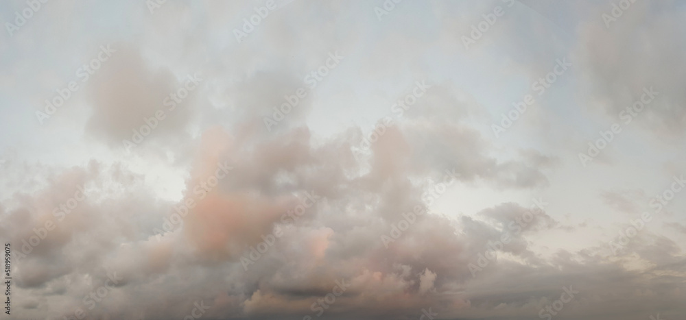 Cloudy sky before thunderstorm with red and gray color clouds, panoramic background.