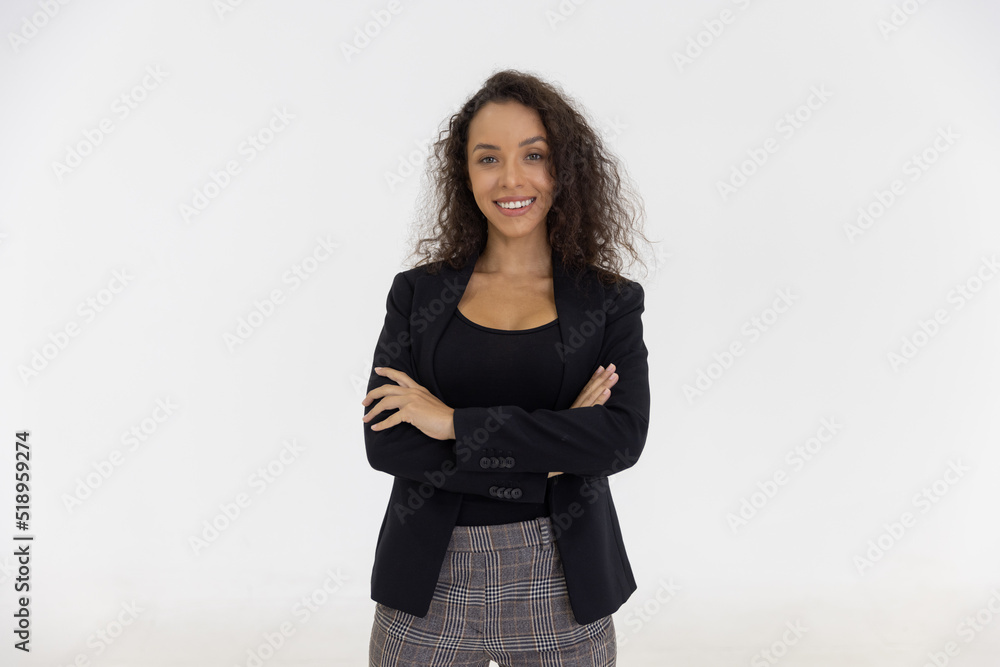 Portrait of smart caucasian businesswoman with curly hair in black jacket suite with trousers smiling arm crossed isolate on white background, vertical full body studio shot Portrait of smart caucasian businesswoman with curly hair in black jacket suite with trousers smiling arm crossed isolate on white background, vertical full body studio shot