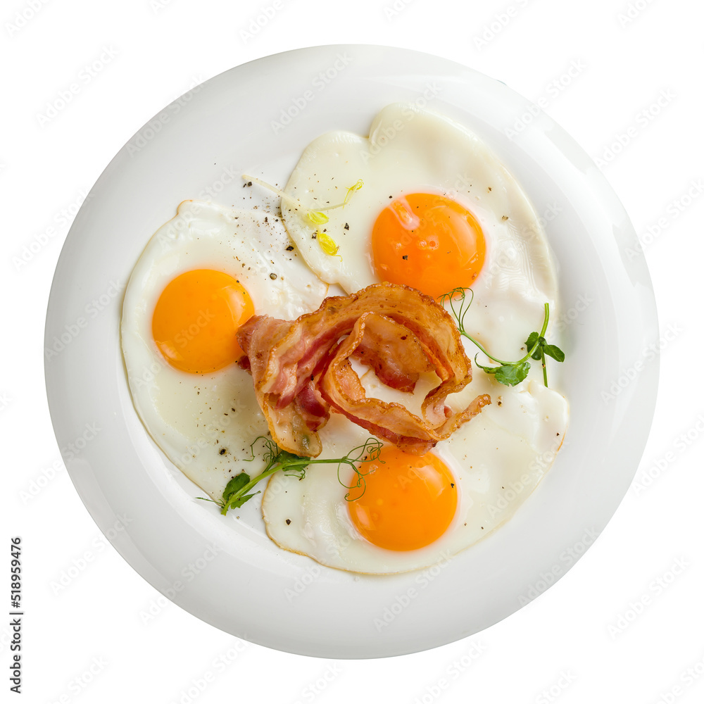 Fried eggs with bacon on white plate isolated on white background top view Fried eggs with bacon on white plate isolated on white background top view