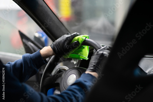 cleaning steering wheel, car detailing studio © Mihail