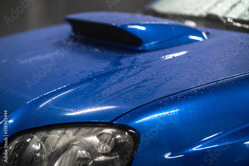 car shiny hydrophobic coating, close up waterdrops on the automobile photo
