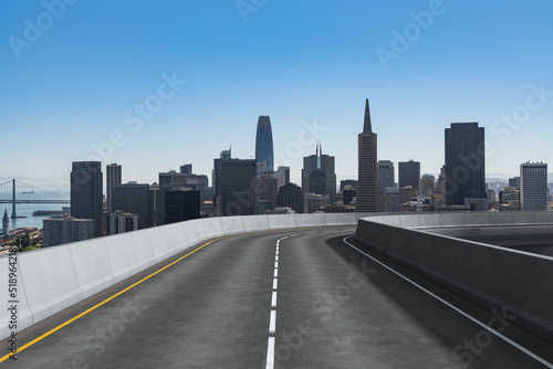 Empty urban asphalt road exterior with city buildings background. New modern highway concrete construction. Concept way to success. Transportation logistic industry fast delivery. San Francisco. USA.