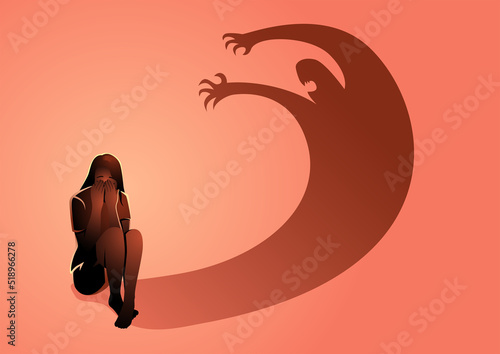 Sad depressed woman sitting on the floor frightened by his own shadow photo
