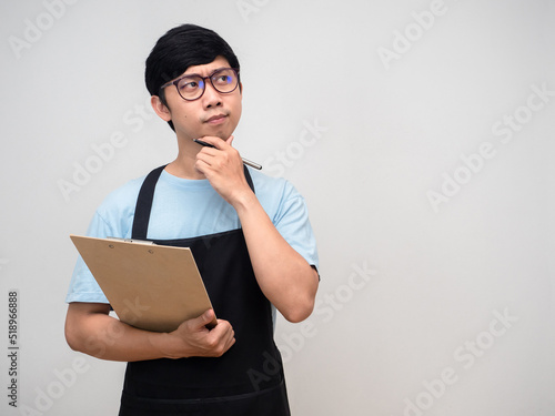 Young merchant holding check list board gesture thinking hesitate copy space
