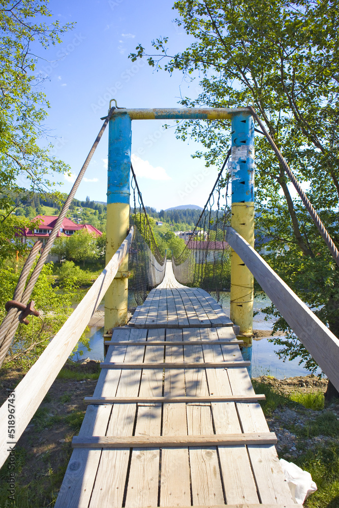 Wooden suspension bridge over the Black Cheremysh River in Verkhovyna, Ukraine Wooden suspension bridge over the Black Cheremysh River in Verkhovyna, Ukraine