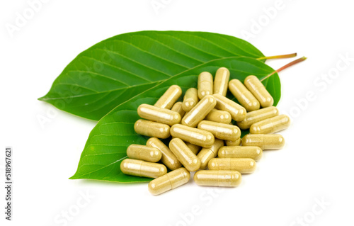 Mitragyna Speciosa Korth or kratom capsules with green leaf isolated on white background. 