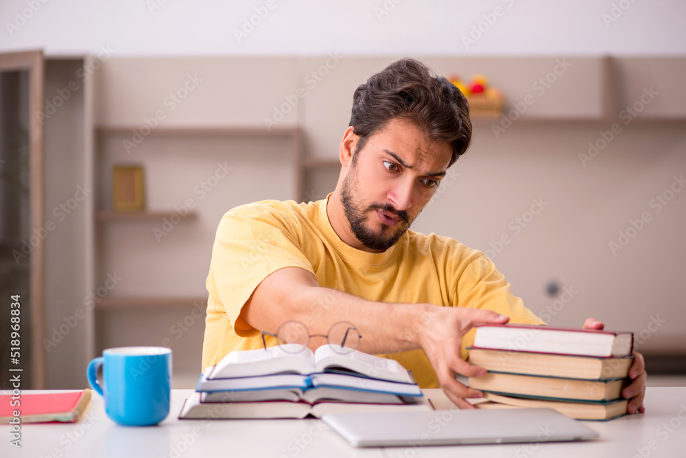 Young male student preparing for exams at home Young male student preparing for exams at home