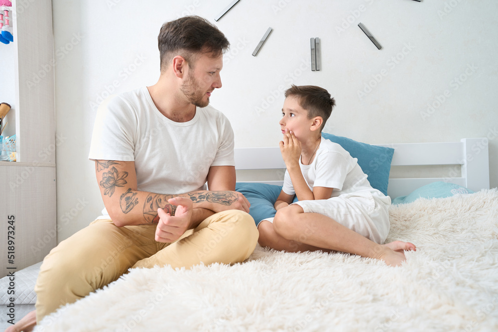 Fototapeta premium Boy complains to his dad about toothache and feeling unwell