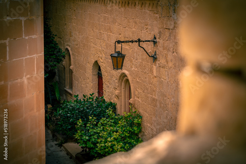 One of the old, vintage looking entrances and characteristic lamp. Mdina, Malta. photo