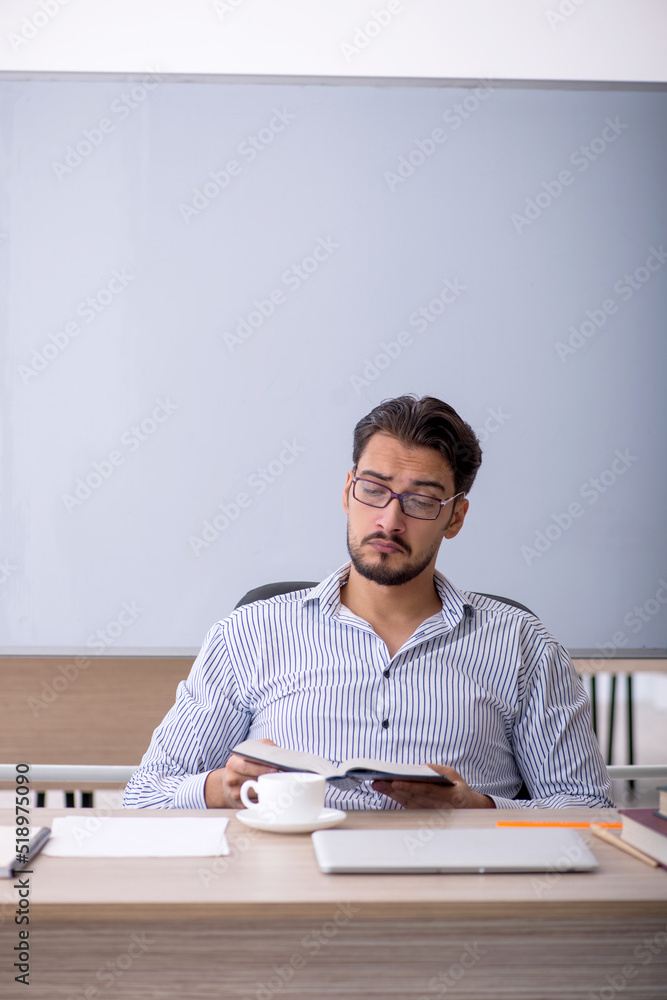 Fototapeta premium Young male teacher in the classroom