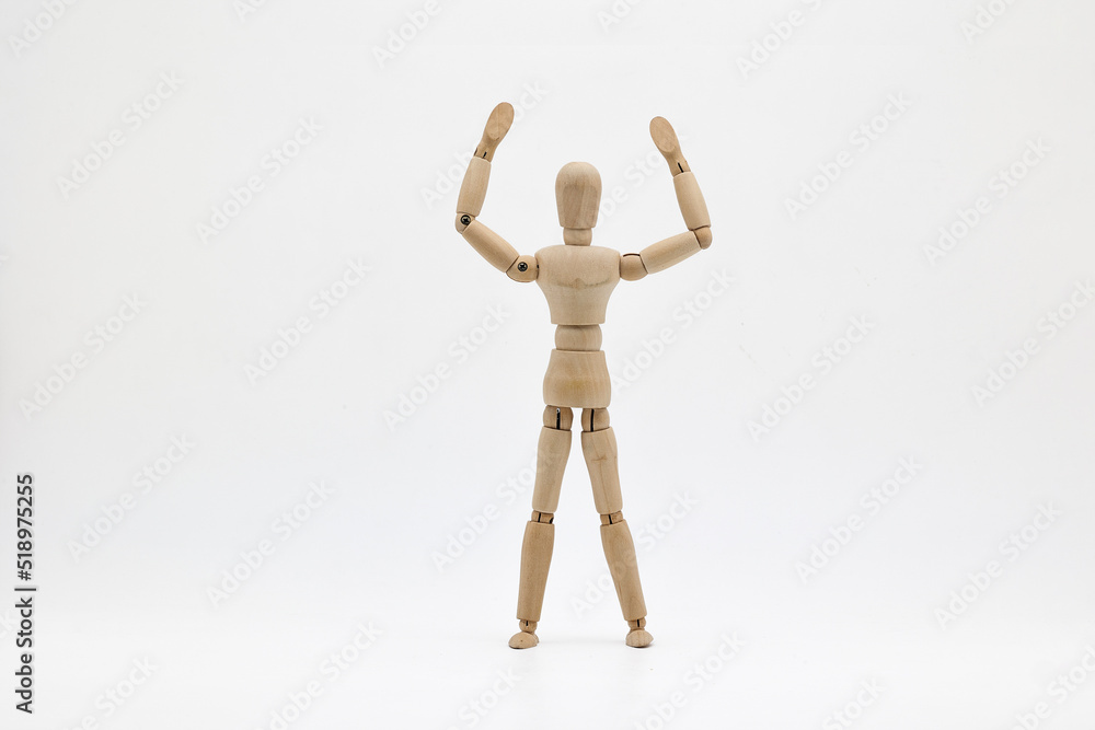 Wooden puppet raising hands on a white background. Wooden puppet raising hands on a white background.