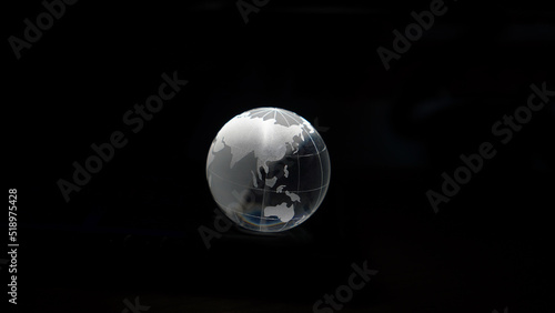 Glass crystal globe ball shine in dark background with black copy space internation global concept © glowonconcept