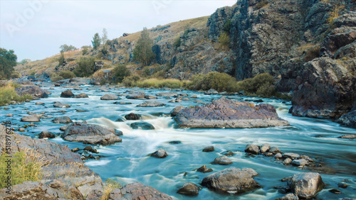 Beautiful River water flowing through stones and rocks at dawn. Video. Flow of the river through the stones. Timelapse photo