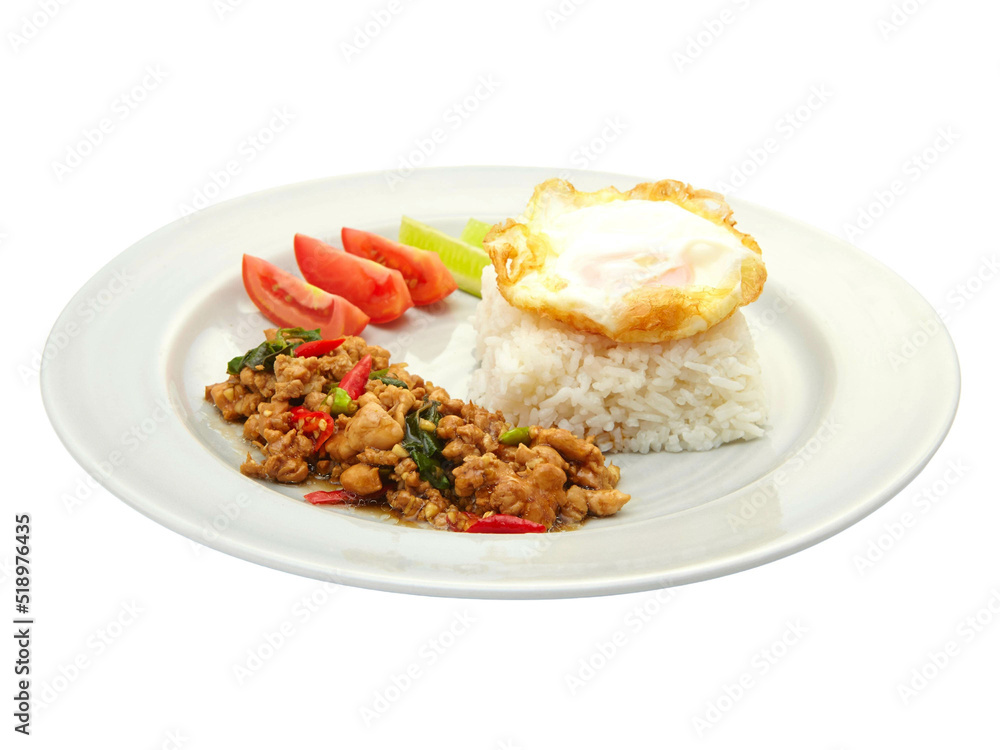 Thai Food Stir-Fried Chicken Spicy and Basil served with Rice ,Fried egg and tomato cucumber carved white plate side view isolated on white background Thai Food Stir-Fried Chicken Spicy and Basil served with Rice ,Fried egg and tomato cucumber carved white plate side view isolated on white background