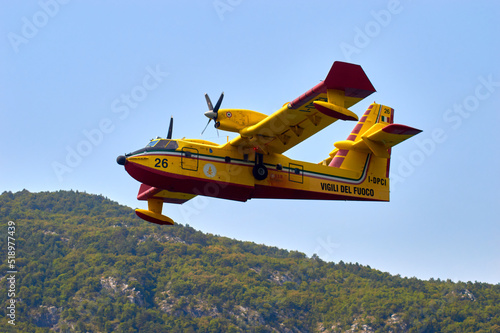 Canadair in fase di ricarica presso il lago di Cavazzo, Udine, Italia photo