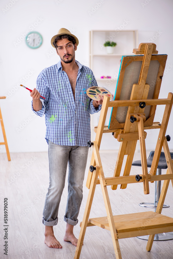 Young man enjoying painting at the studio Young man enjoying painting at the studio
