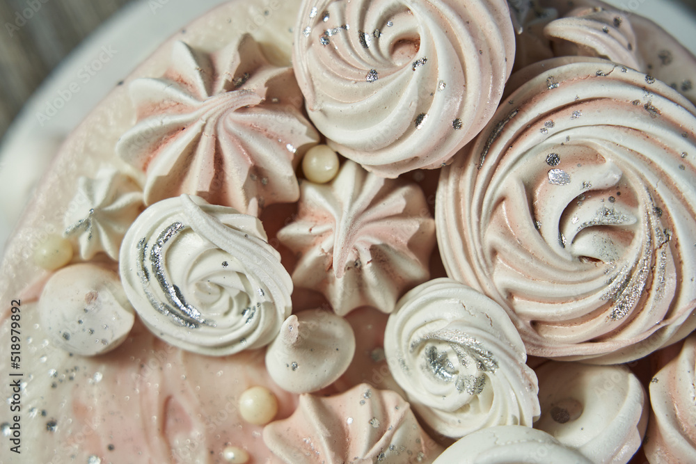 birthday cake for girls. pink cake decorated with meringues of different shapes. view from above birthday cake for girls. pink cake decorated with meringues of different shapes. view from above