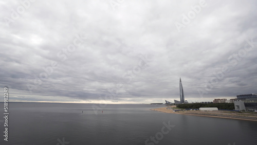 Russia  St. Petersburg  panoramic view of skyscraper Lakhta center at day time. Action. Highest skyscraper in Europe and the heavy cloudy sky above Neva river.