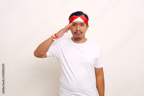 Asian man standing with respect gesture. Indonesian independence day concept. Isolated on white