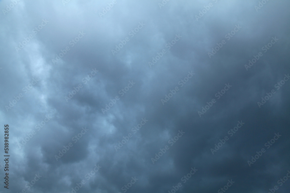 Atmosphere and formation of rain. Low hanging clouds with rain on the background of a gray sky. Rain clouds, texture, background. Gray sky and bad weather in summer. Climate change