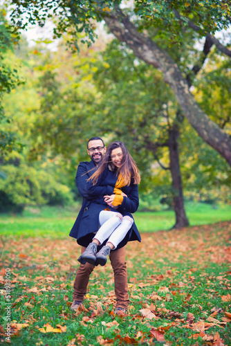 Young couple walking in the park in autumn © Solid photos