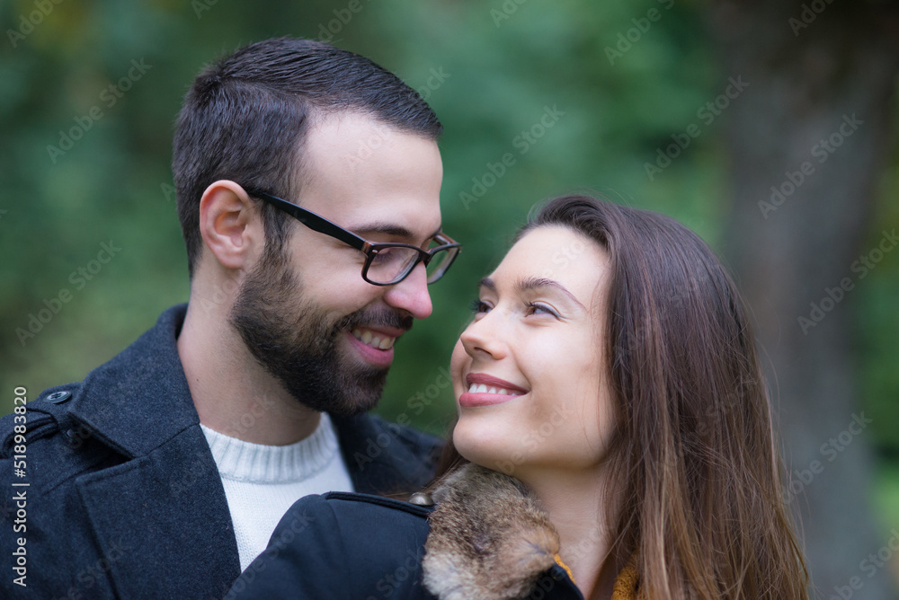 Young couple walking in the park in autumn Young couple walking in the park in autumn