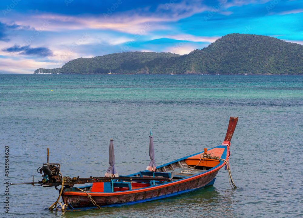 Colourful Skies Sunset over Rawai Beach in Phuket island Thailand. Lovely turquoise blue waters, lush green mountains colourful skies and beautiful views of Pa Tong Patong