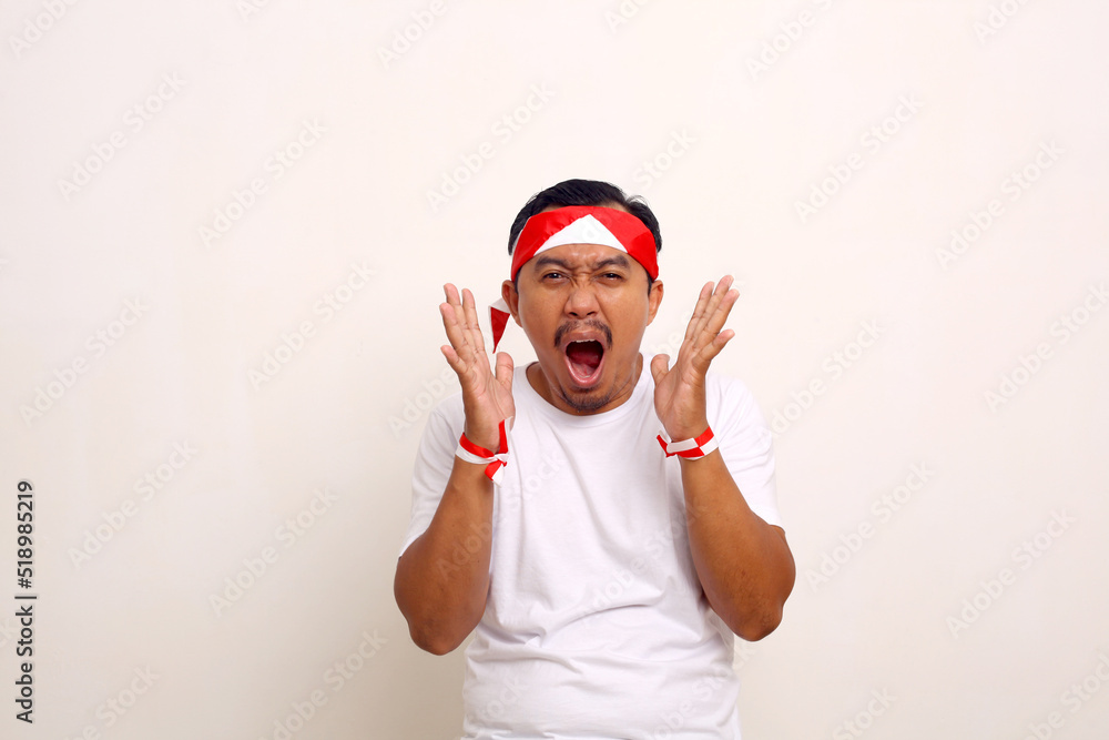 Wow and amazed expression of asian man while standing. Indonesian Independence day concept
