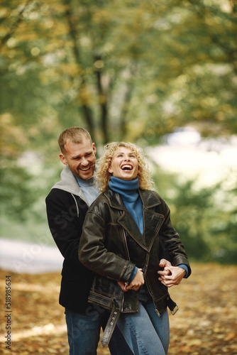 Romantic couple standing in a forest, hugging and posing for a photo © hetmanstock2