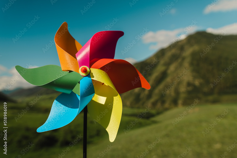 Symbol of clean green energy, Close-up multi-colored pinwheel ...