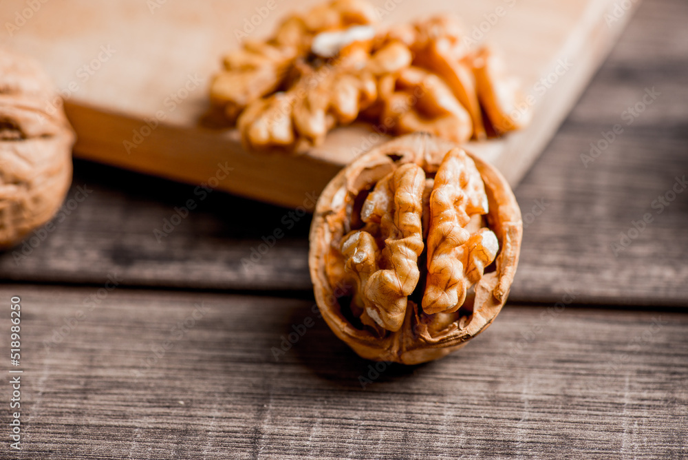 Fototapeta premium Walnuts kernels on wood desk with detail background, walnut on wood kitchen underlay.