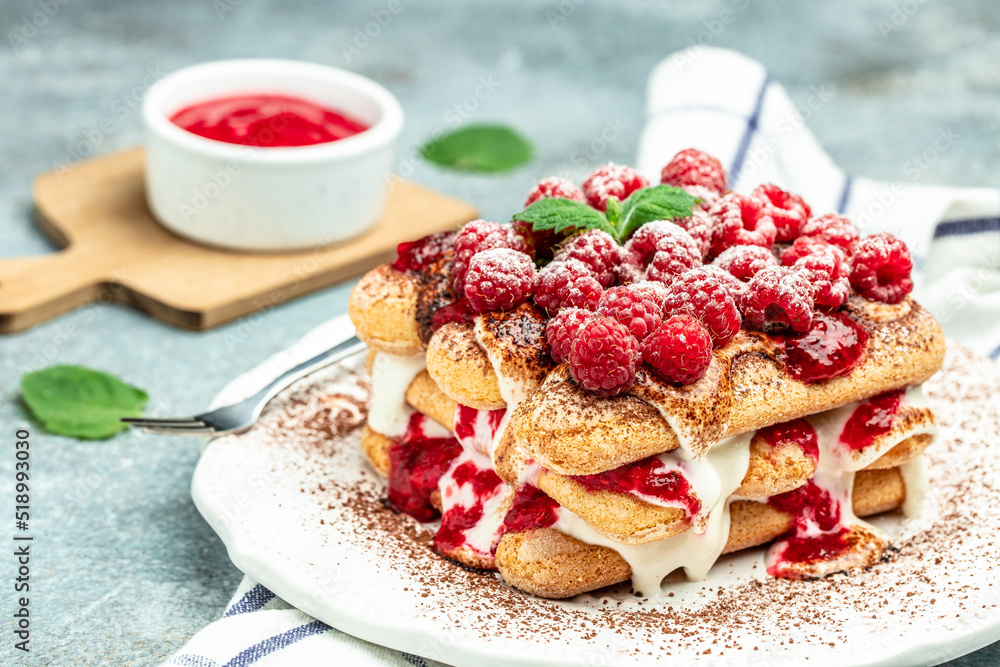 berry tiramisu with biscuit with coffee cream and fresh berries. Tiramisu with raspberry on a light background berry tiramisu with biscuit with coffee cream and fresh berries. Tiramisu with raspberry on a light background