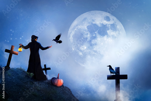 Fototapeta The sorcerer and birds in the cemetery at the moon
