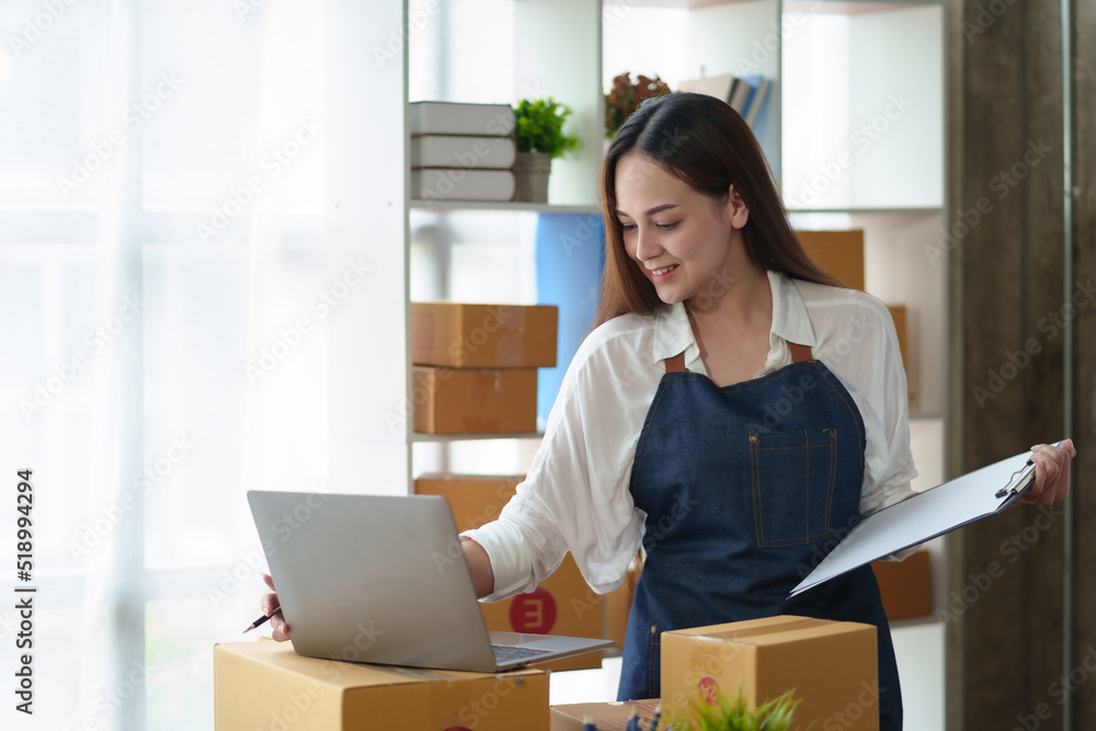 Online business owner Asian woman are using computer to check orders and customer addresses so that they can be delivered to their customers correctly. Online business owner Asian woman are using computer to check orders and customer addresses so that they can be delivered to their customers correctly.