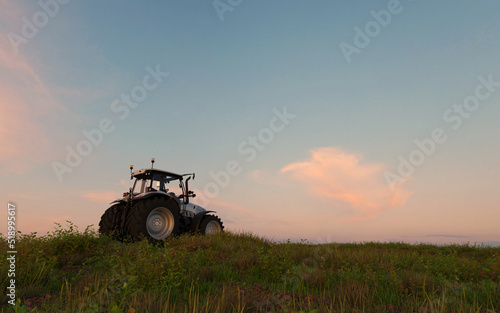 Tractor preparing land during sunrise or sunset