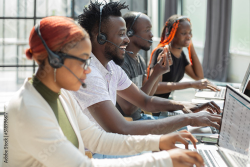 Group of african people working on laptops in a call centre photo