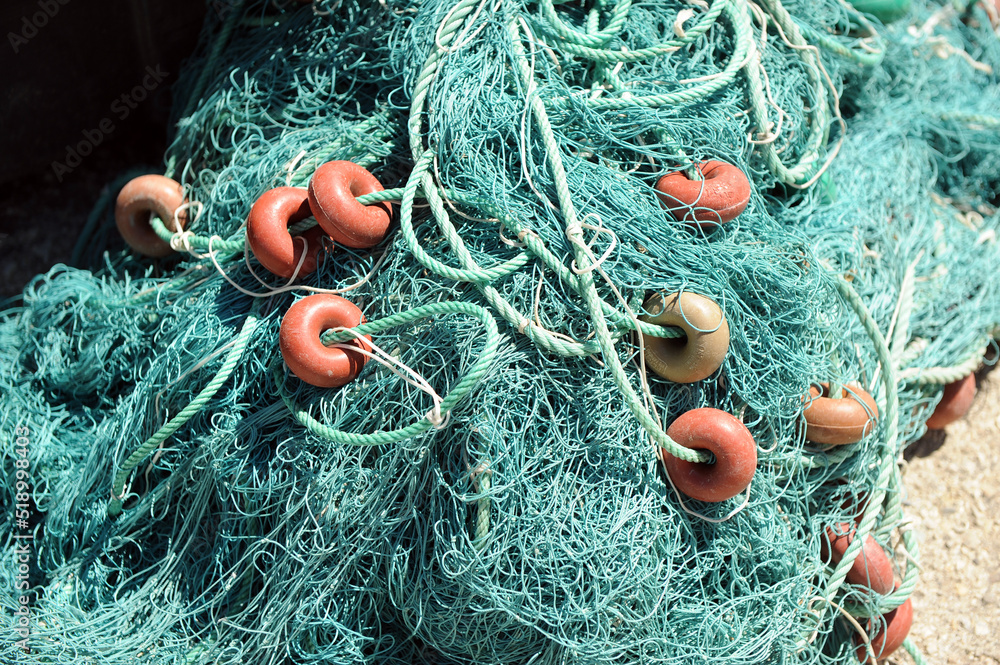 Fishing nets and plastic floats stacked in the fishing port of Rota, Cadiz coast, Spain