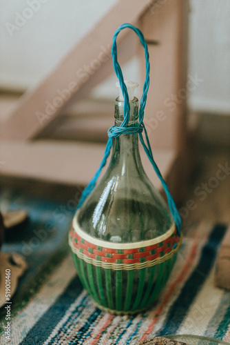 Interior of traditional house-museum from inside. Antique glass bottle for wine, kitchen utensil in Ethno museum 