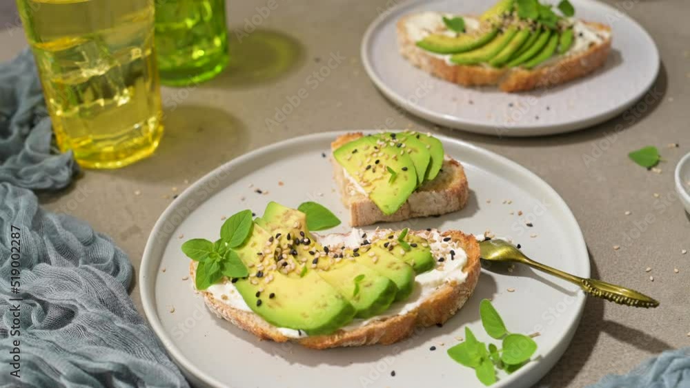 Healthy toast with avocado cream cheese and wheat bread on a plate. Delicious snacks and avocado sandwiches. Food composition, tasty Italian meal. Healthy toast with avocado cream cheese and wheat bread on a plate. Delicious snacks and avocado sandwiches. Food composition, tasty Italian meal.