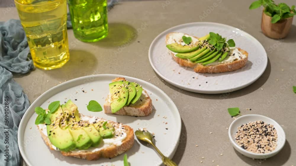Healthy toast with avocado cream cheese and wheat bread on a plate. Delicious snacks and avocado sandwiches. Food composition, tasty Italian meal. Healthy toast with avocado cream cheese and wheat bread on a plate. Delicious snacks and avocado sandwiches. Food composition, tasty Italian meal.
