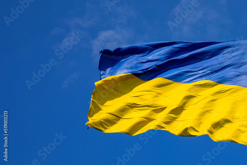 Flag of Ukraine on a background of blue sky. The largest flag in Ukraine.