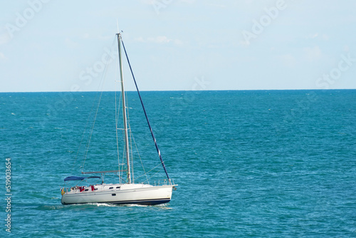 Yacht boat floats on the sea against the background of the horizon.