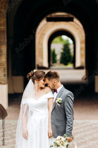 A loving couple stands in a churchyard
