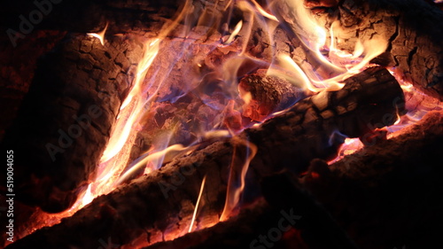 Campfire burning with a lot of ember and heat, with strong colors with a sensation of incandescent heat.