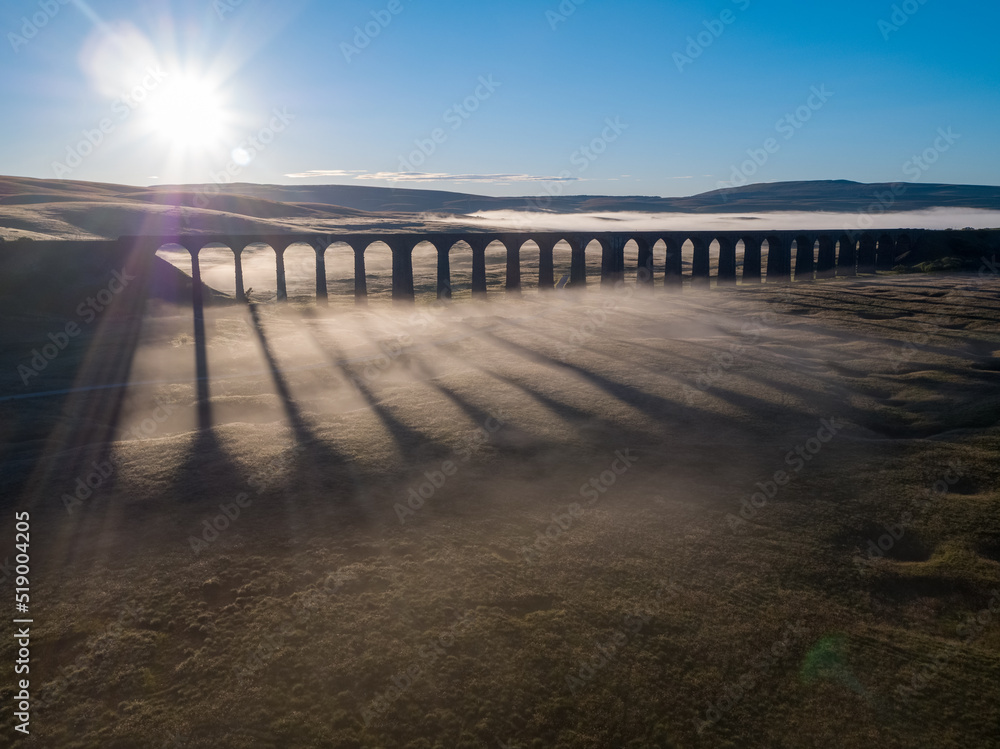 Drone view of the Iconic landmark Ribblehead Viaduct shrouded in early morning Mist