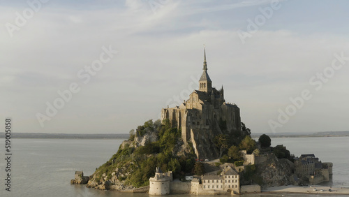 Beautiful Mont Saint Michel cathedral located on the island, Normandy, Northern France, Europe. Action. Panoramic view of famous historic tidal island with stunning castle.