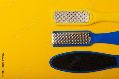 Фотография Foot file and grater on yellow background