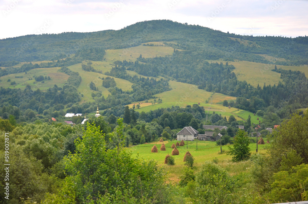 Landscape of summer village in the Carpathian mountains. Travelling to the mountains , trip to the Carpathian mountains concept Landscape of summer village in the Carpathian mountains. Travelling to the mountains , trip to the Carpathian mountains concept