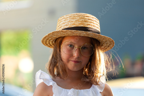 outdoor portrait of cute little girl in glasses