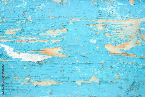 Old background with shabby cracked blue paint